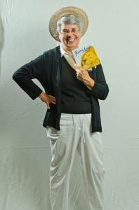 Photo of woman wearing a hat, holding a book